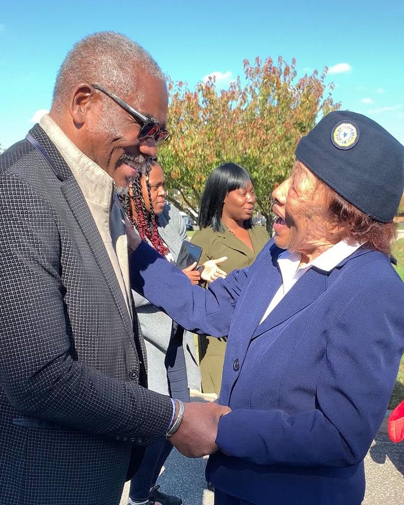 Congressman Gregory Meeks holding a woman's hand