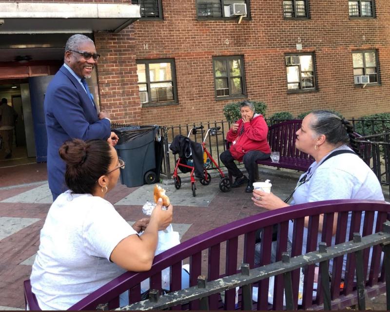 Congressman Gregory Meeks with people outside a building